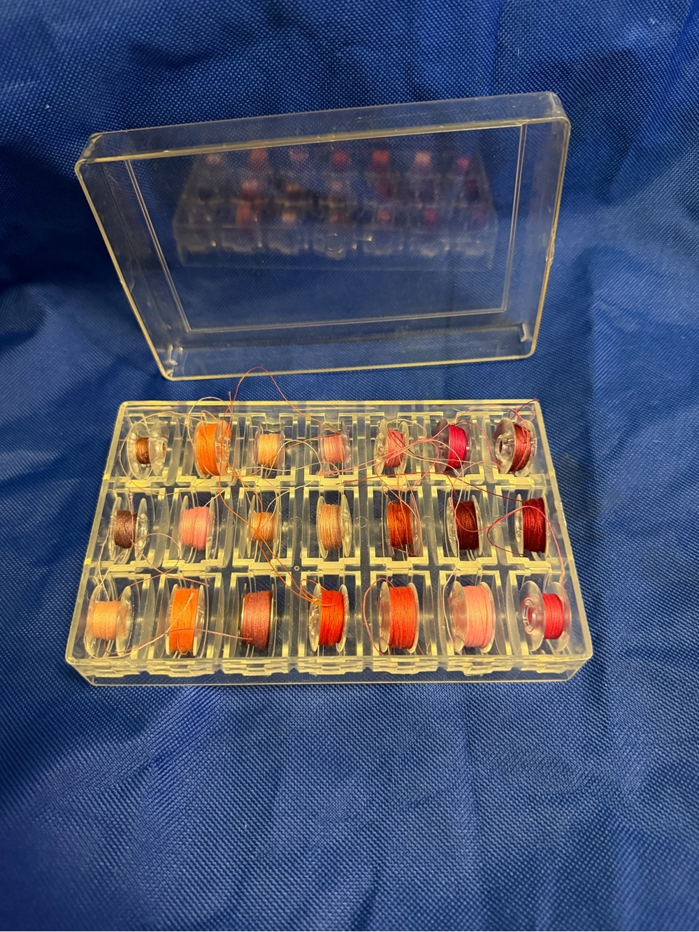 Two Assorted Red & Orange Sewing Bobbin Set of 21 each in Clear Case
